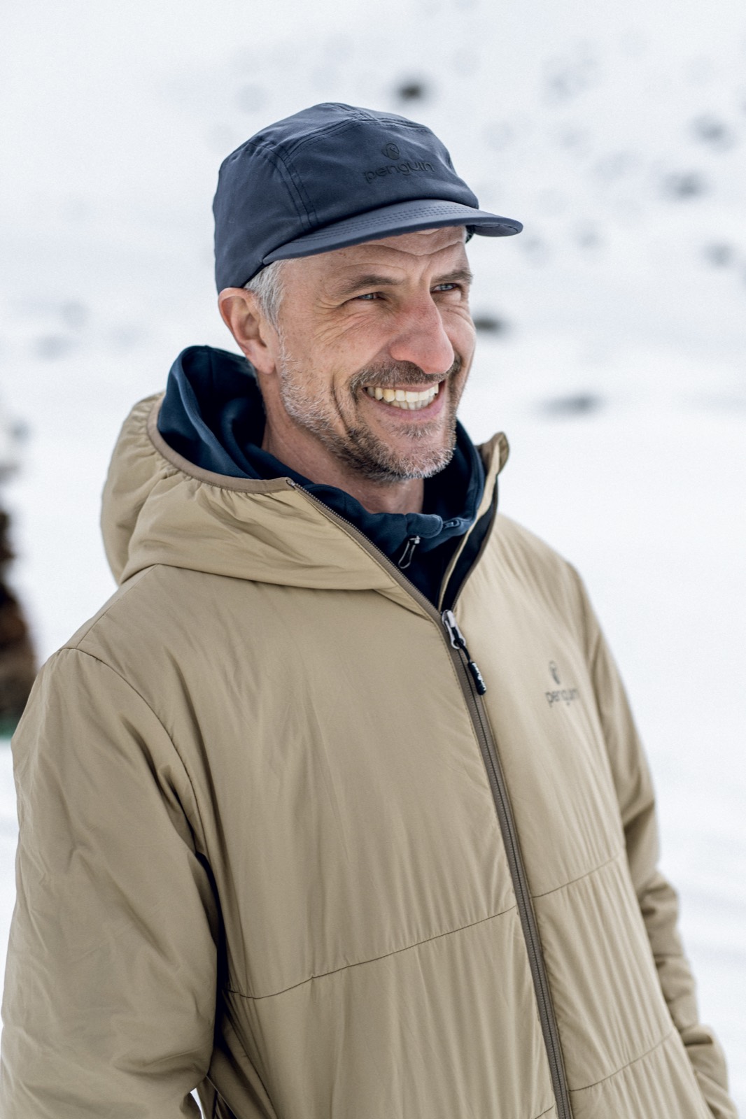 Ambassador portrait on an alpine ridge in full winter kit